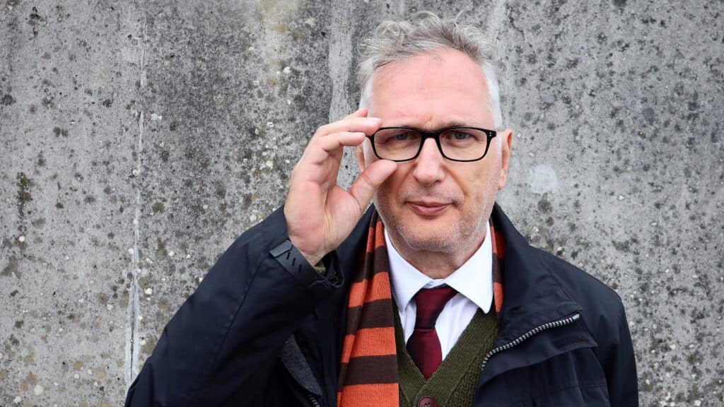 Herny Normal touching his glasses